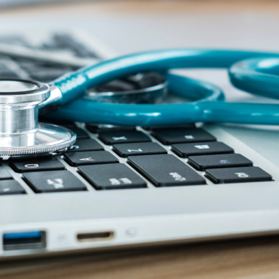 Closeup of stethoscope on laptop keyboard
