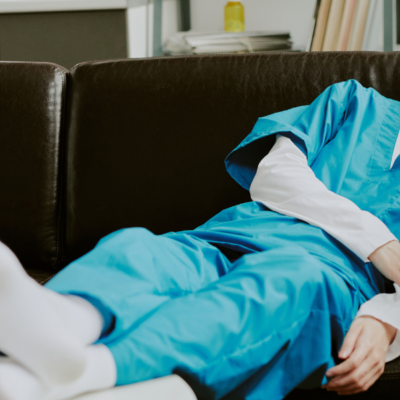 Doctor asleep on couch in break room