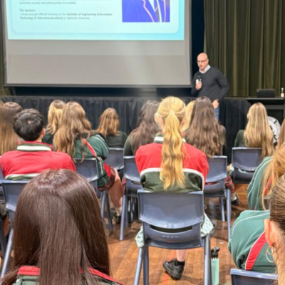 Reza Forozandeh speaking to high school students forward