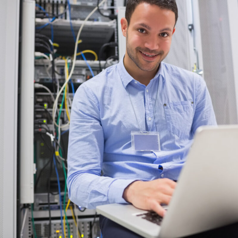 Worker using laptop with open comms panel