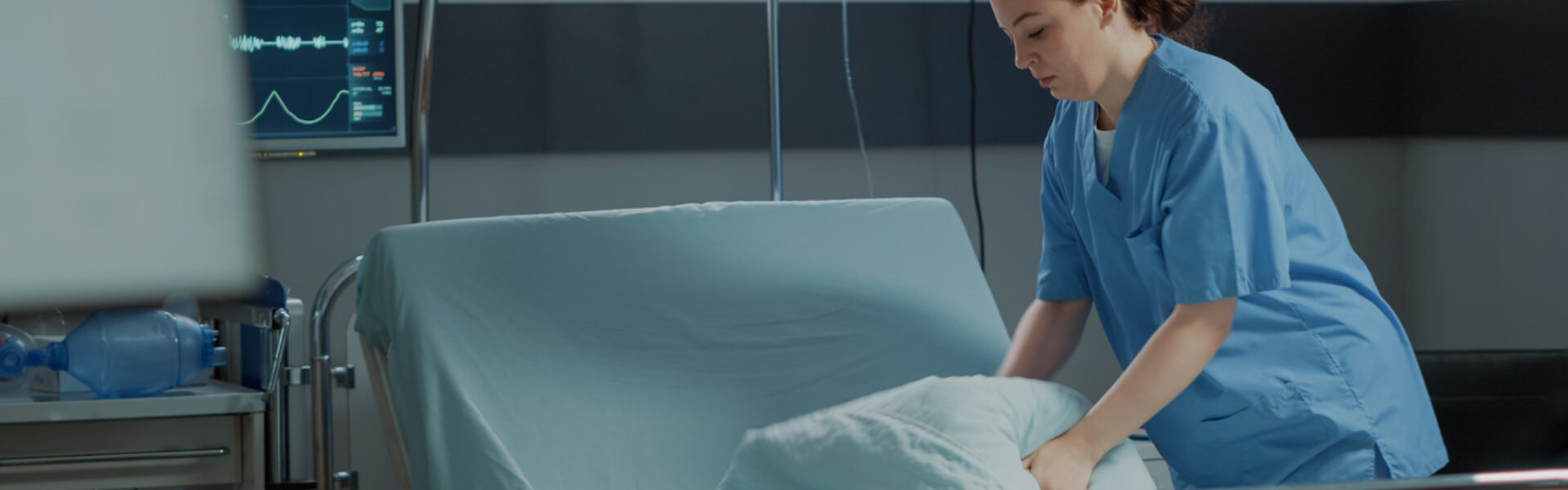 Nurse changing hospital linens